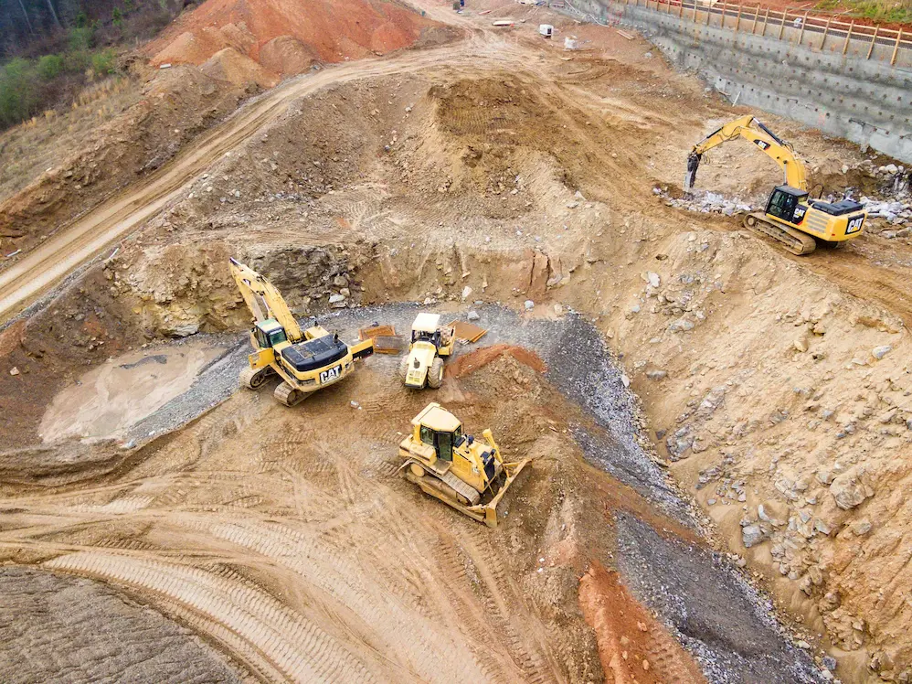 Excavators conducting ground investigation and site assessment